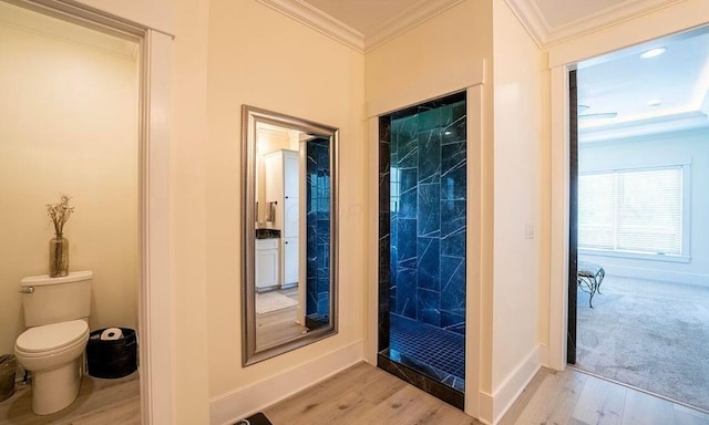 doorway to outside featuring ornamental molding and light hardwood / wood-style flooring