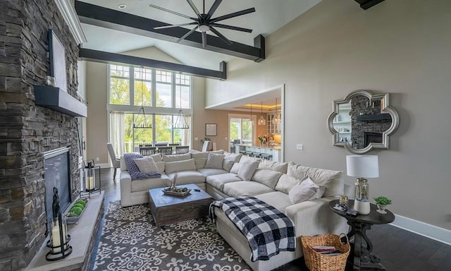 living room featuring a stone fireplace, high vaulted ceiling, and wood-type flooring