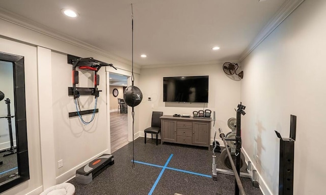 exercise room featuring crown molding