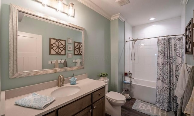 full bathroom featuring crown molding, hardwood / wood-style floors, toilet, shower / tub combo with curtain, and vanity