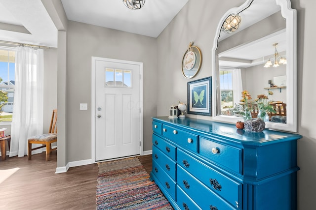 entryway featuring dark hardwood / wood-style floors and an inviting chandelier