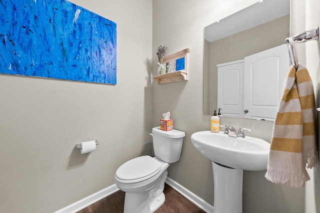 bathroom featuring hardwood / wood-style floors, toilet, and sink