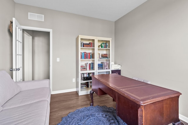 home office with dark hardwood / wood-style floors