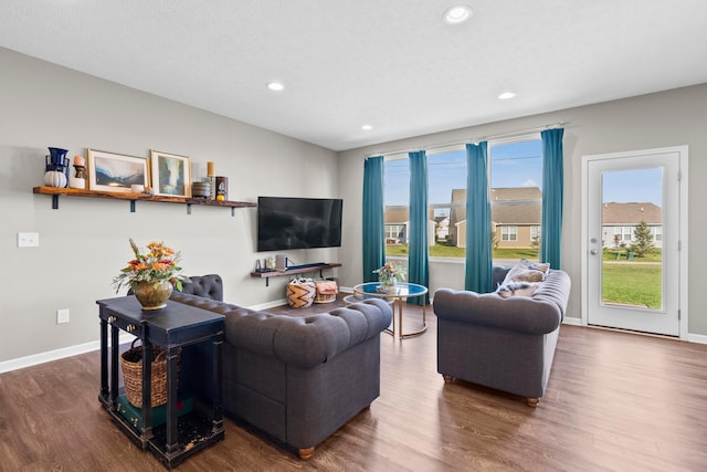 living room with dark wood-type flooring and a textured ceiling