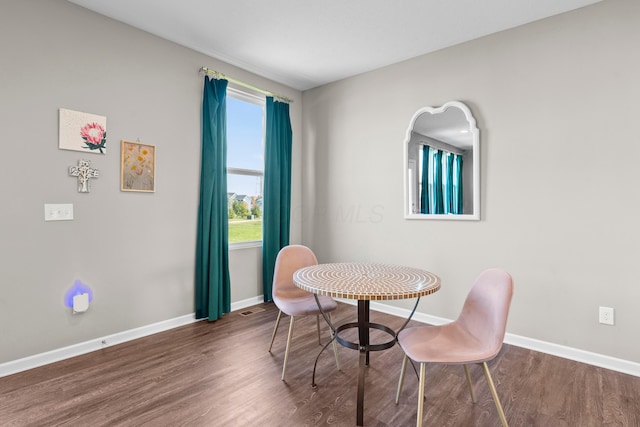 dining space featuring dark hardwood / wood-style flooring