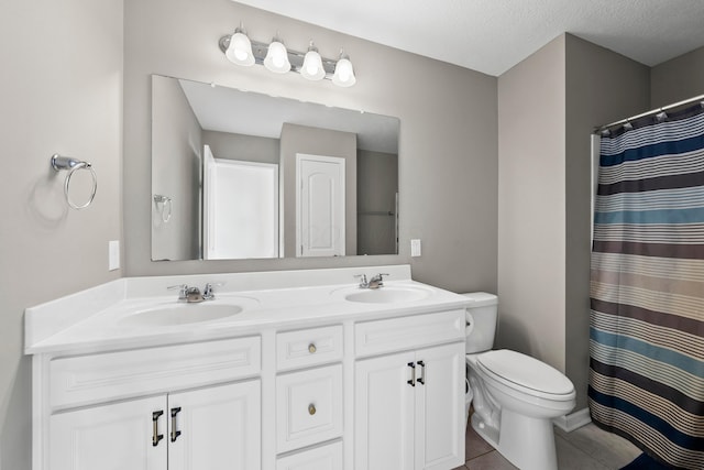 bathroom featuring tile patterned flooring, a textured ceiling, toilet, vanity, and a shower with shower curtain