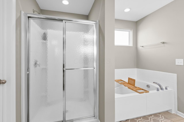 bathroom with separate shower and tub and tile patterned flooring