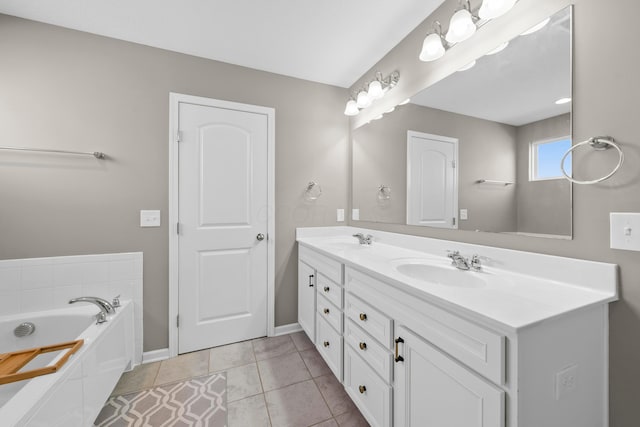 bathroom with tile patterned floors, vanity, and a tub