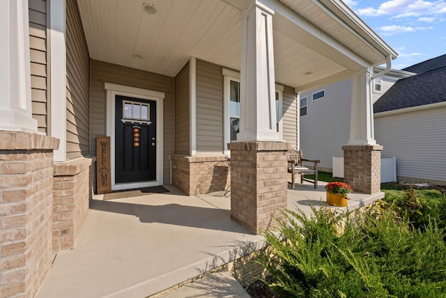 view of exterior entry with covered porch