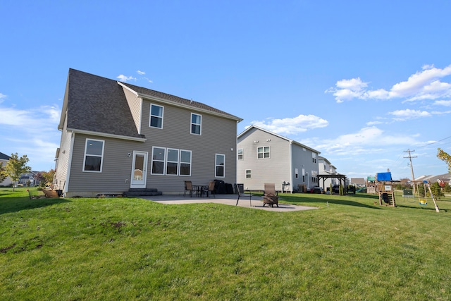 back of property featuring a lawn and a patio area