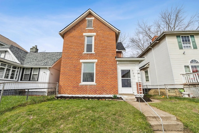 rear view of house with a lawn