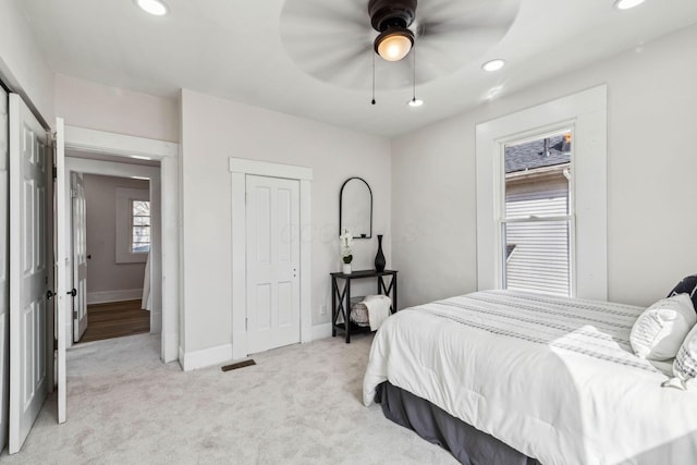 bedroom with ceiling fan and light colored carpet