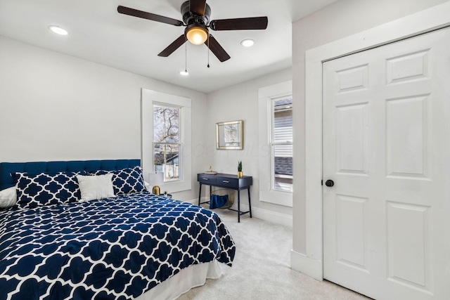 bedroom featuring light carpet, a closet, and ceiling fan