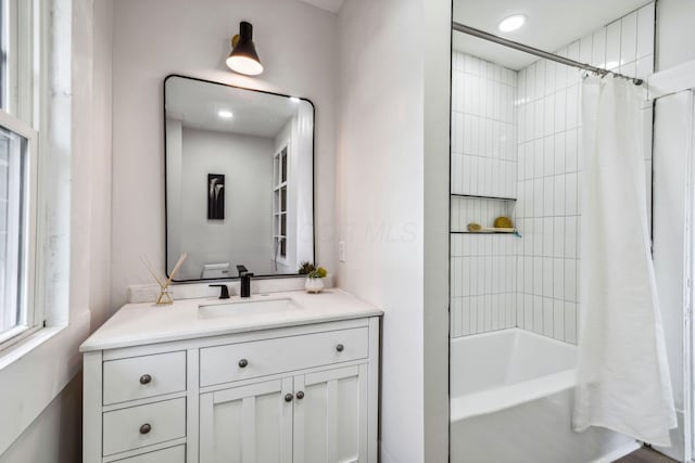 bathroom featuring shower / tub combo and vanity