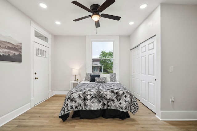 bedroom featuring ceiling fan, a closet, and light hardwood / wood-style flooring