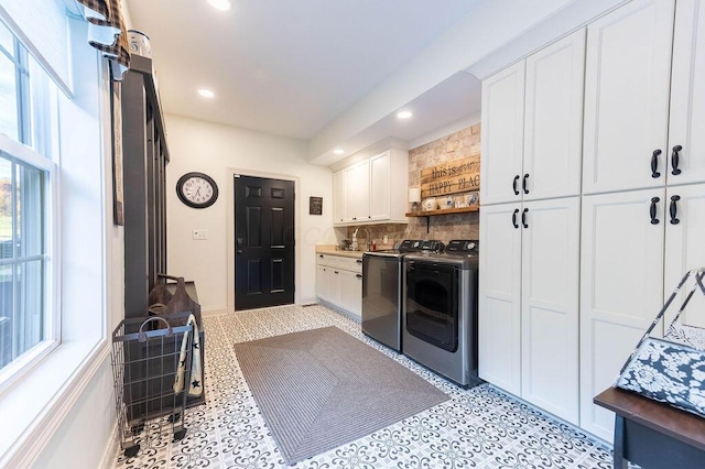 laundry room with washer and dryer, sink, and cabinets