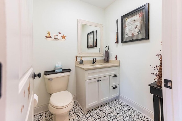 bathroom with tile patterned floors, vanity, and toilet