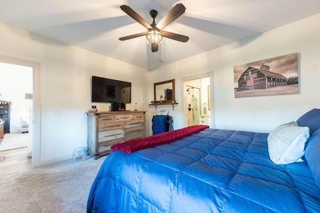 bedroom featuring ensuite bath, ceiling fan, and carpet