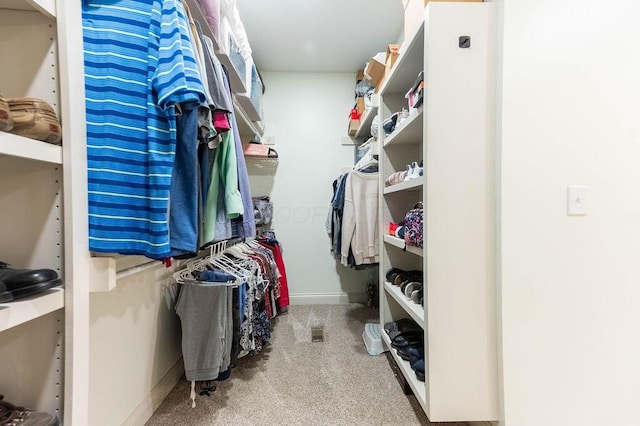 walk in closet with carpet flooring