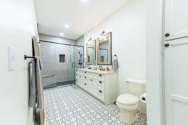 bathroom with vanity, an enclosed shower, and toilet