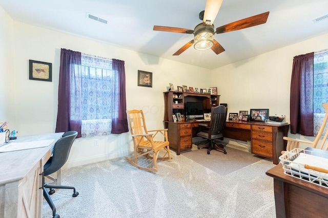 carpeted office featuring ceiling fan