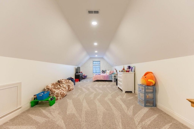 bedroom featuring light colored carpet and lofted ceiling