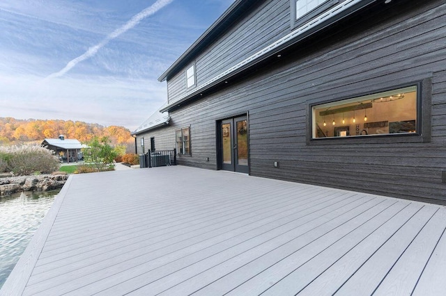 wooden terrace featuring cooling unit