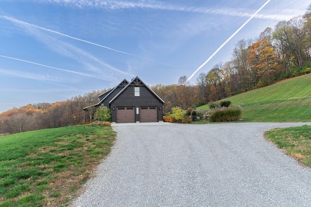 view of home's exterior featuring an outbuilding, a garage, and a lawn