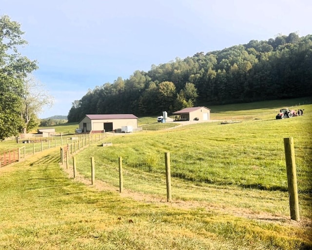 view of yard featuring a rural view and an outdoor structure