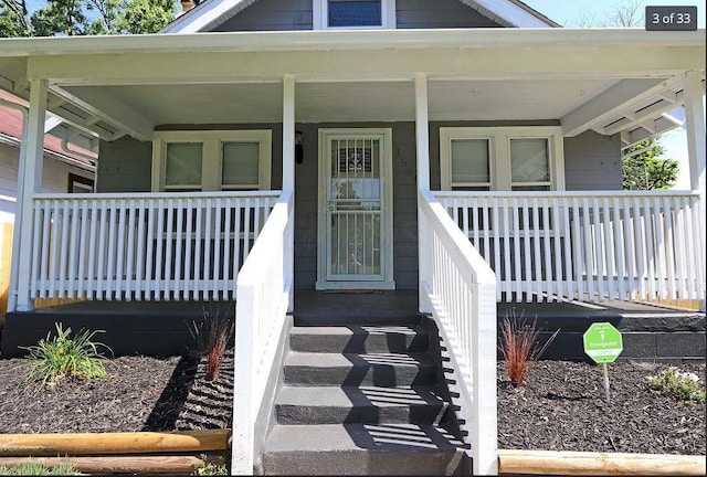 entrance to property featuring a porch