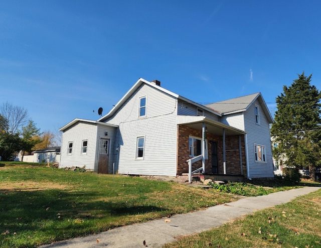 exterior space featuring covered porch and a front yard