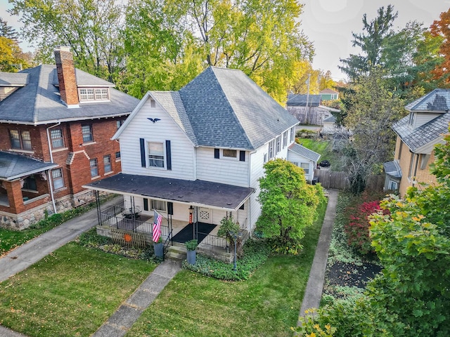 exterior space featuring a lawn and covered porch