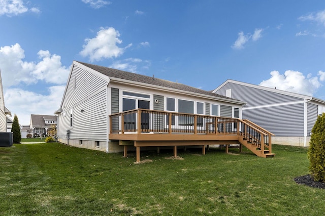 rear view of house featuring a lawn, a deck, and central air condition unit