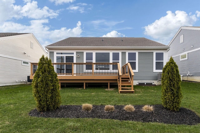 rear view of property with a yard, a deck, and cooling unit