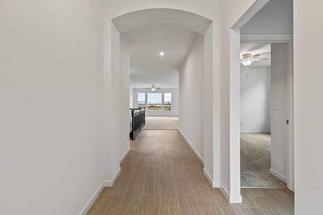 hallway with light colored carpet