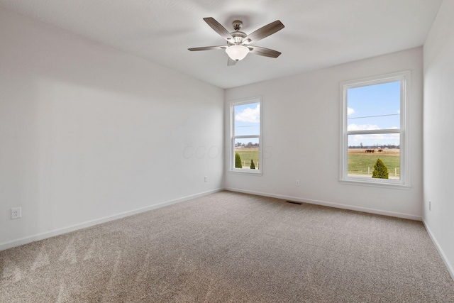 carpeted empty room featuring ceiling fan