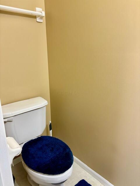 bathroom with tile patterned flooring and toilet