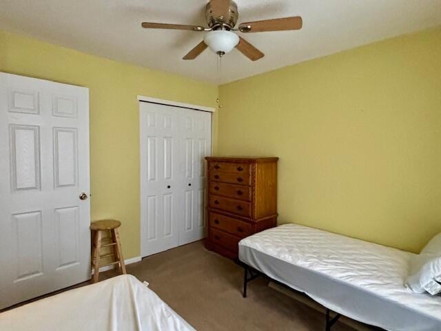 carpeted bedroom featuring a closet and ceiling fan