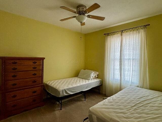 carpeted bedroom with ceiling fan