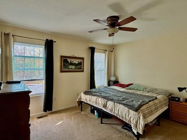 carpeted bedroom with ceiling fan