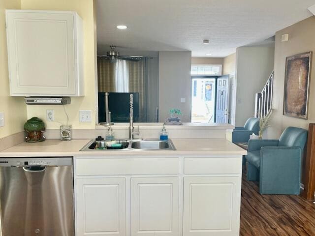 kitchen with dark hardwood / wood-style floors, stainless steel dishwasher, white cabinetry, and sink