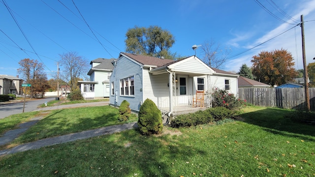 view of front of property with a porch and a front yard