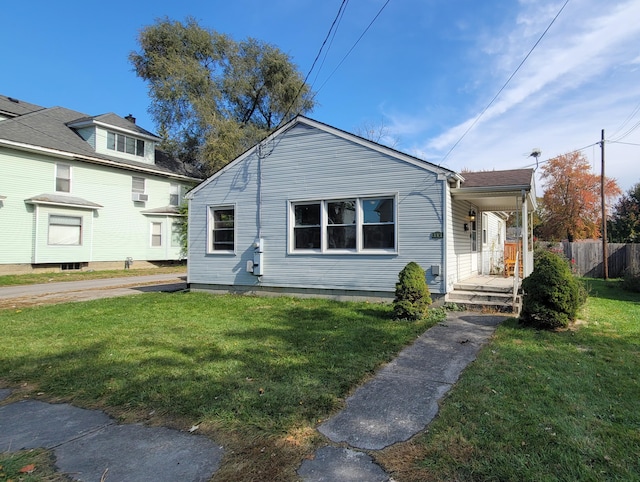 bungalow featuring a porch and a front lawn