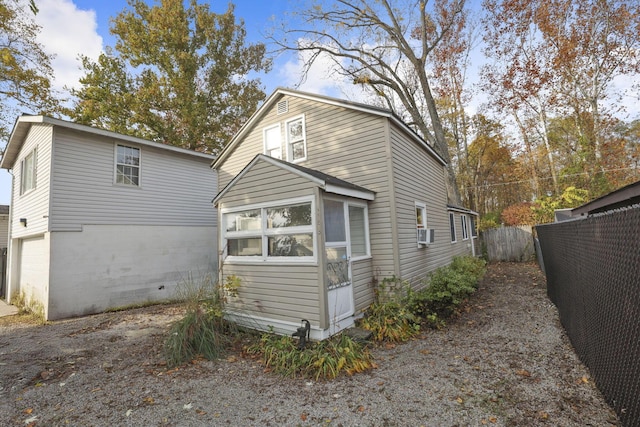 rear view of property with cooling unit