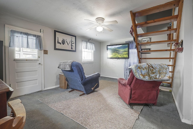 living area with carpet flooring, a textured ceiling, and ceiling fan