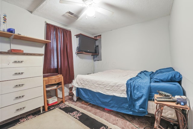 bedroom featuring ceiling fan and a textured ceiling