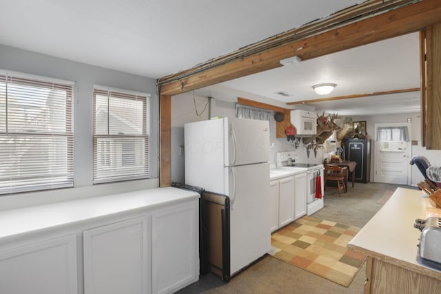 kitchen featuring white cabinets, light colored carpet, and white appliances