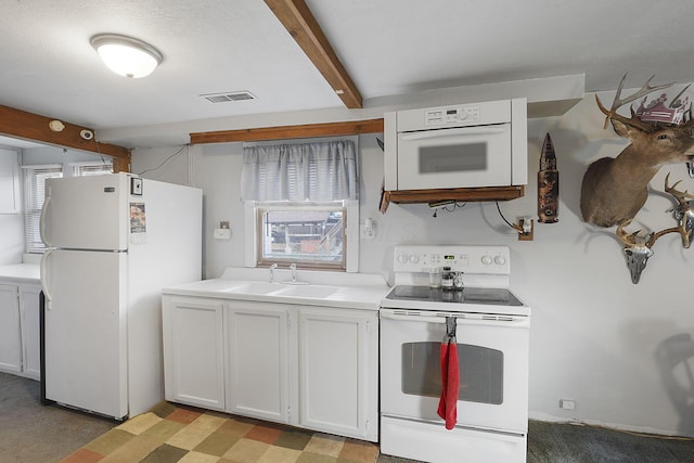 kitchen featuring beam ceiling, sink, light colored carpet, white appliances, and white cabinets