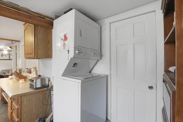 laundry room with stacked washer and dryer