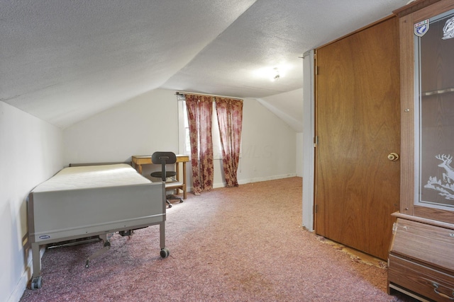 carpeted bedroom featuring a textured ceiling and lofted ceiling